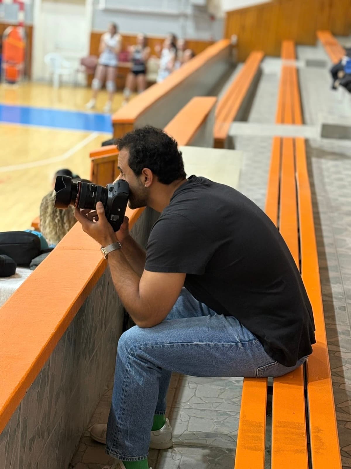 A photographer shooting a match from the stands